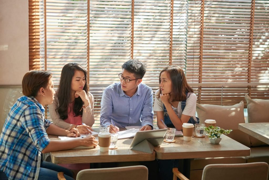 People working around a café table, planning ahead for a slow season in business