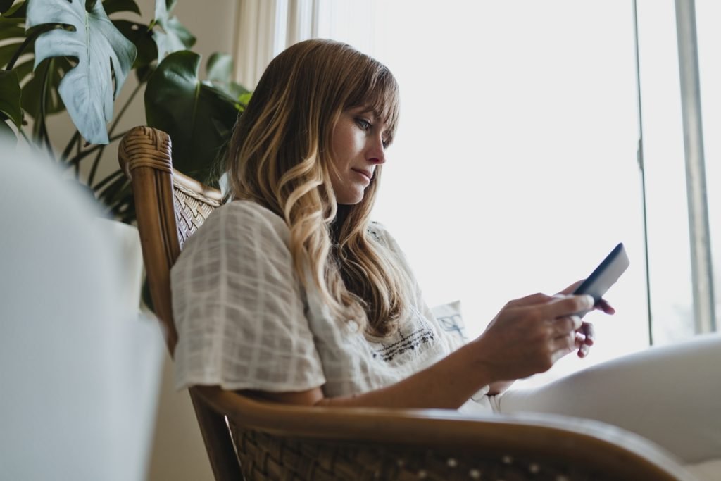 Woman on her phone in a bright room