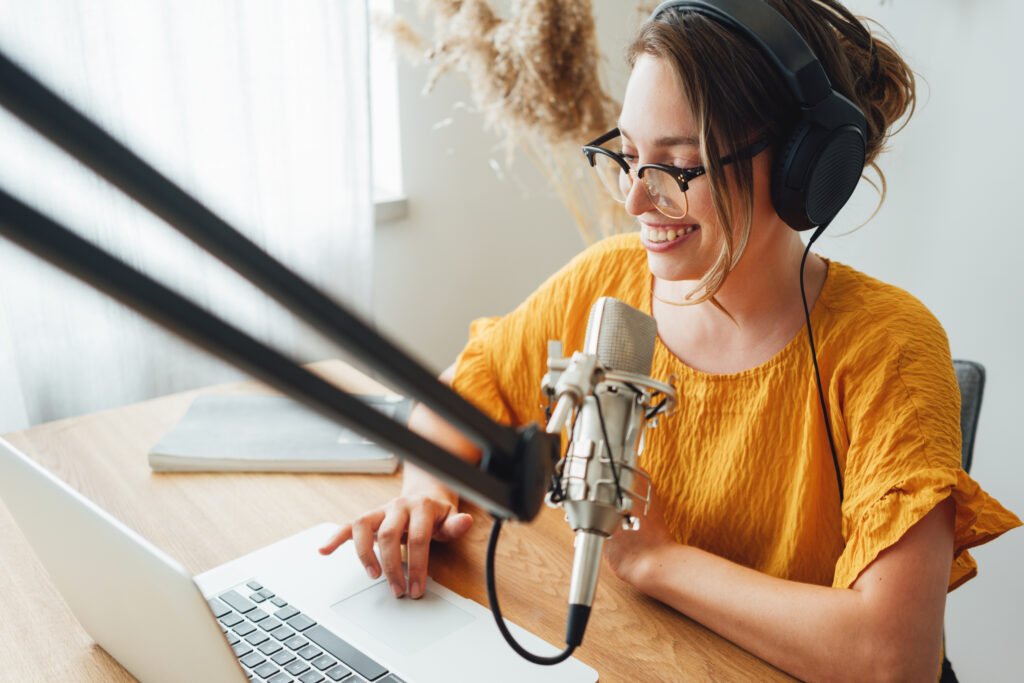 Woman speaking into a microphone while recording a podcast, a simple way to build trust online