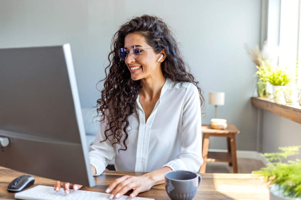 Dark-haired woman at a computer