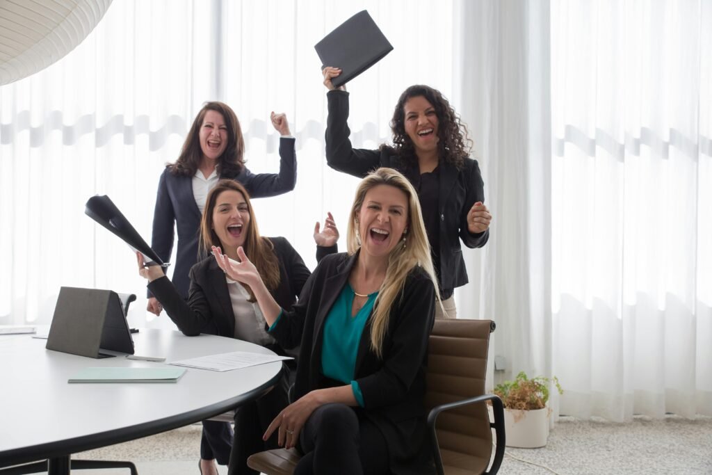 Women celebrating, papers in the air