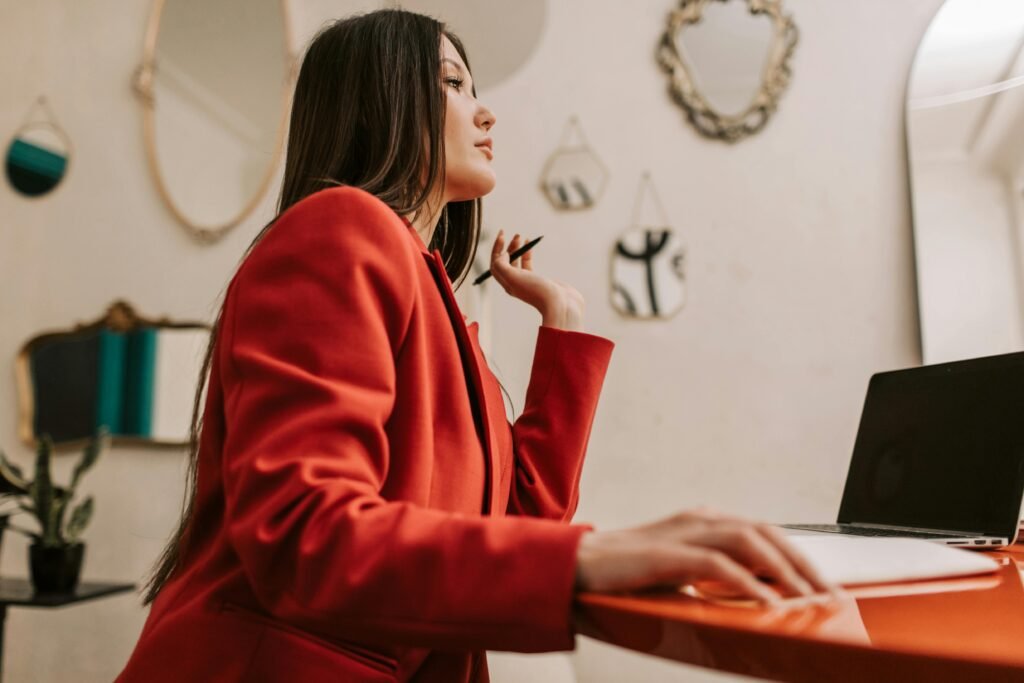 Woman in red working at a laptop