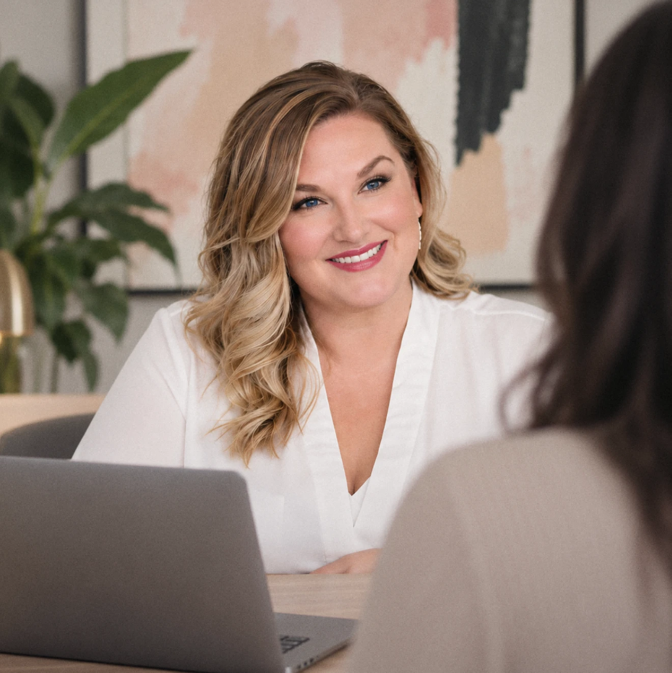 Leeah Murray smiling across the table in a client session