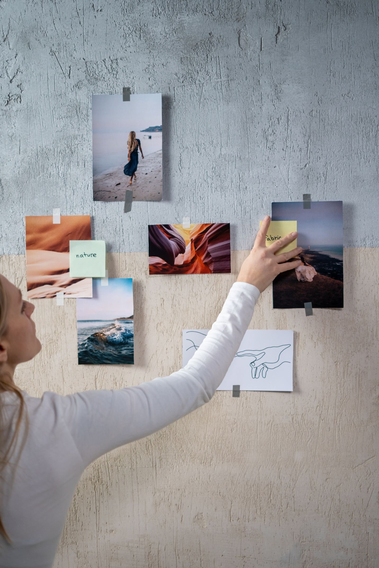 Photos and sticky notes arranged on a textured wall