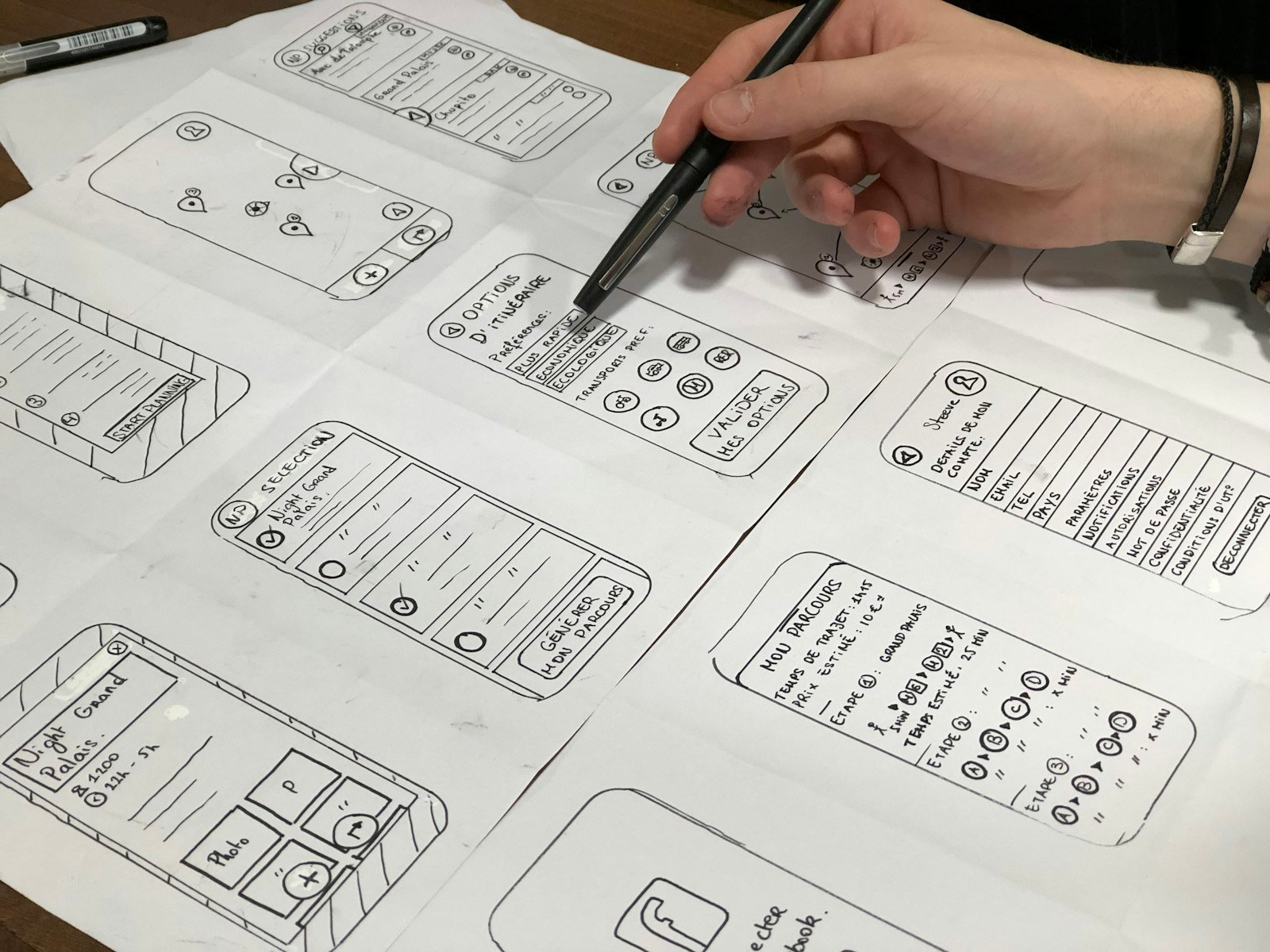 Hand sketching app wireframes on paper