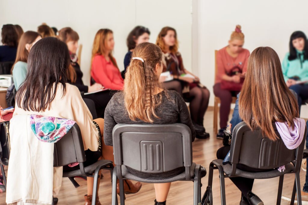 Women sitting in a circle at a workshop, building community for entrepreneurs.
