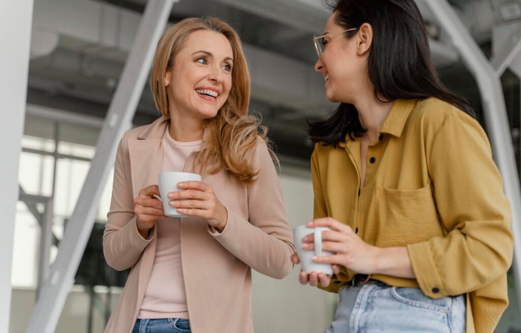 Two businesswomen talking over coffee