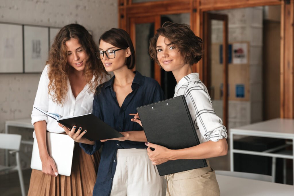 Three businesswomen co-working in an office, figuring out why the business is not making money yet.